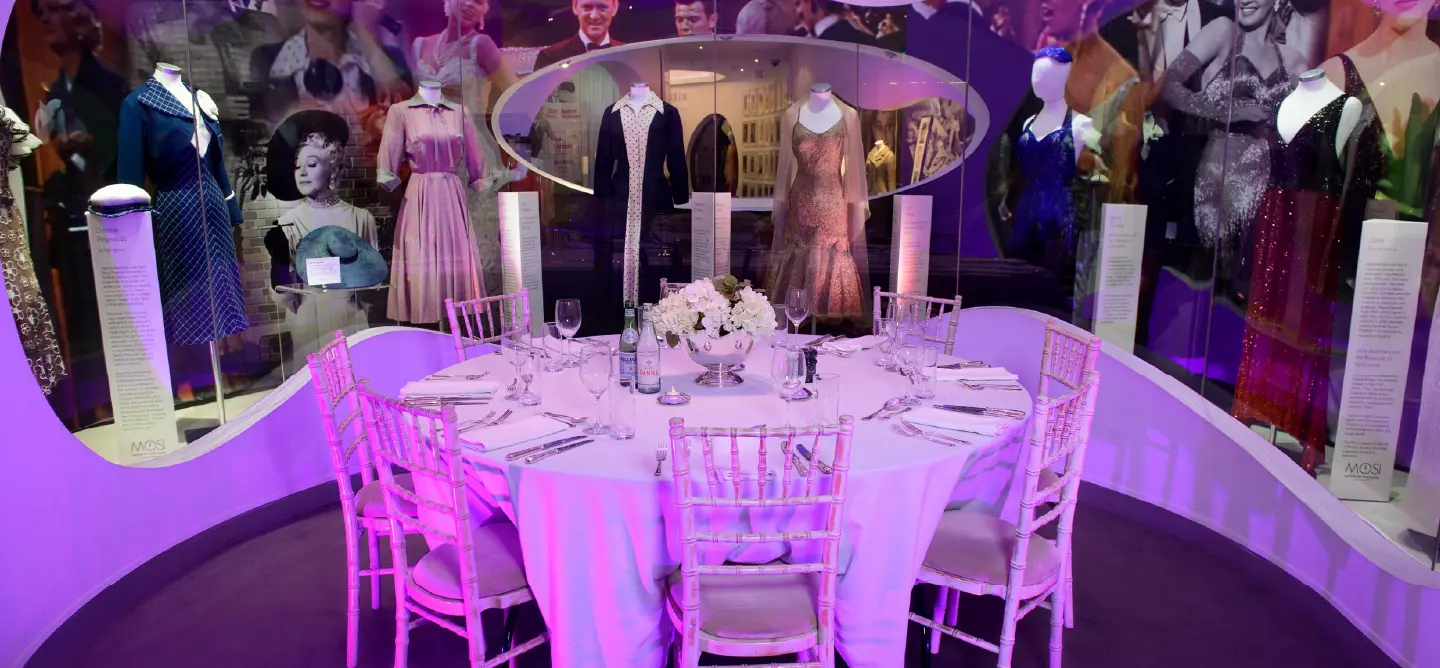 Table surrounded by style icon dresses