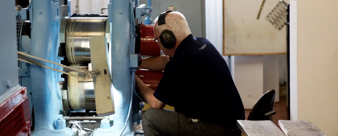 Craftsman working at machine at Newbridge Silverware Visitor Experience